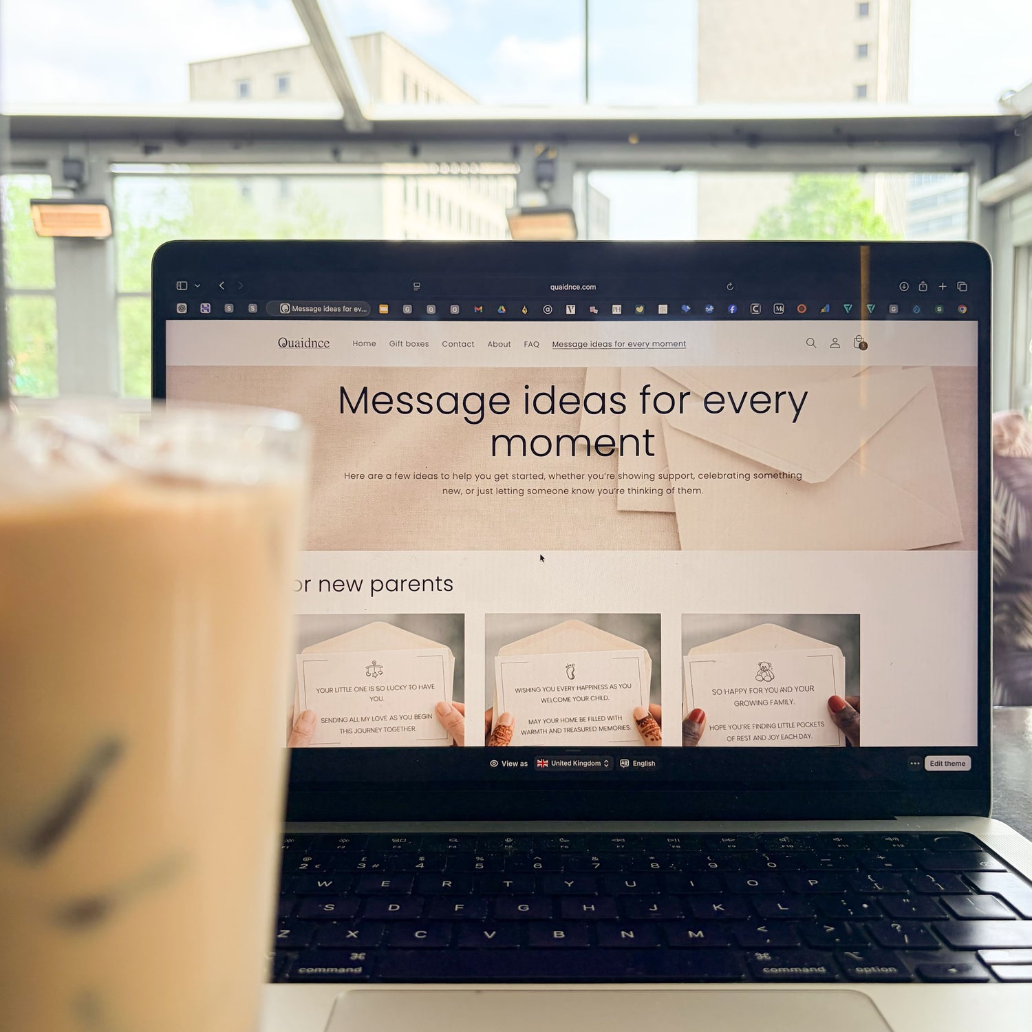 Laptop displaying a website with message ideas on a desk with a blurred coffee cup in the foreground.
