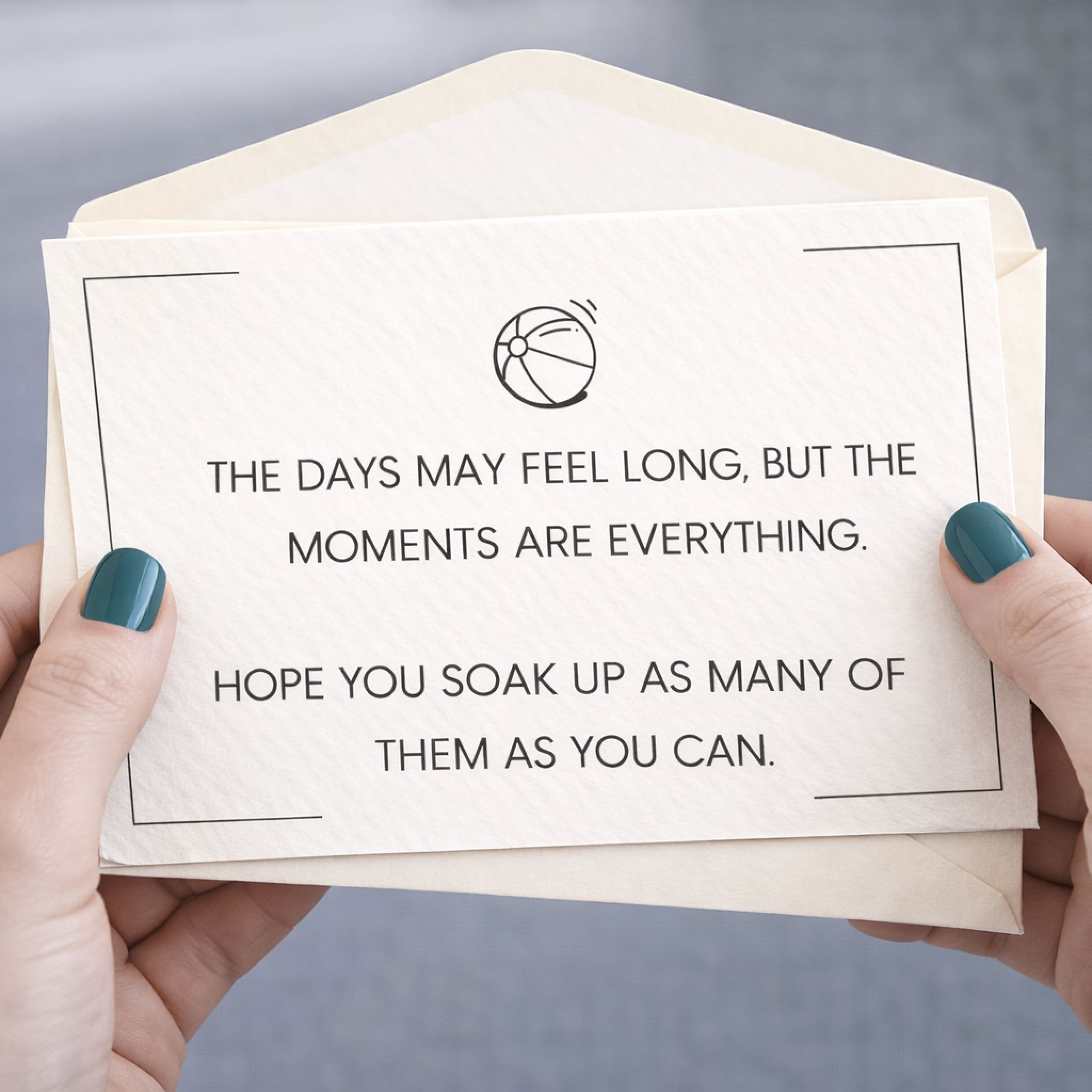Enveloped card with a motivational message held by hands with green nail polish.