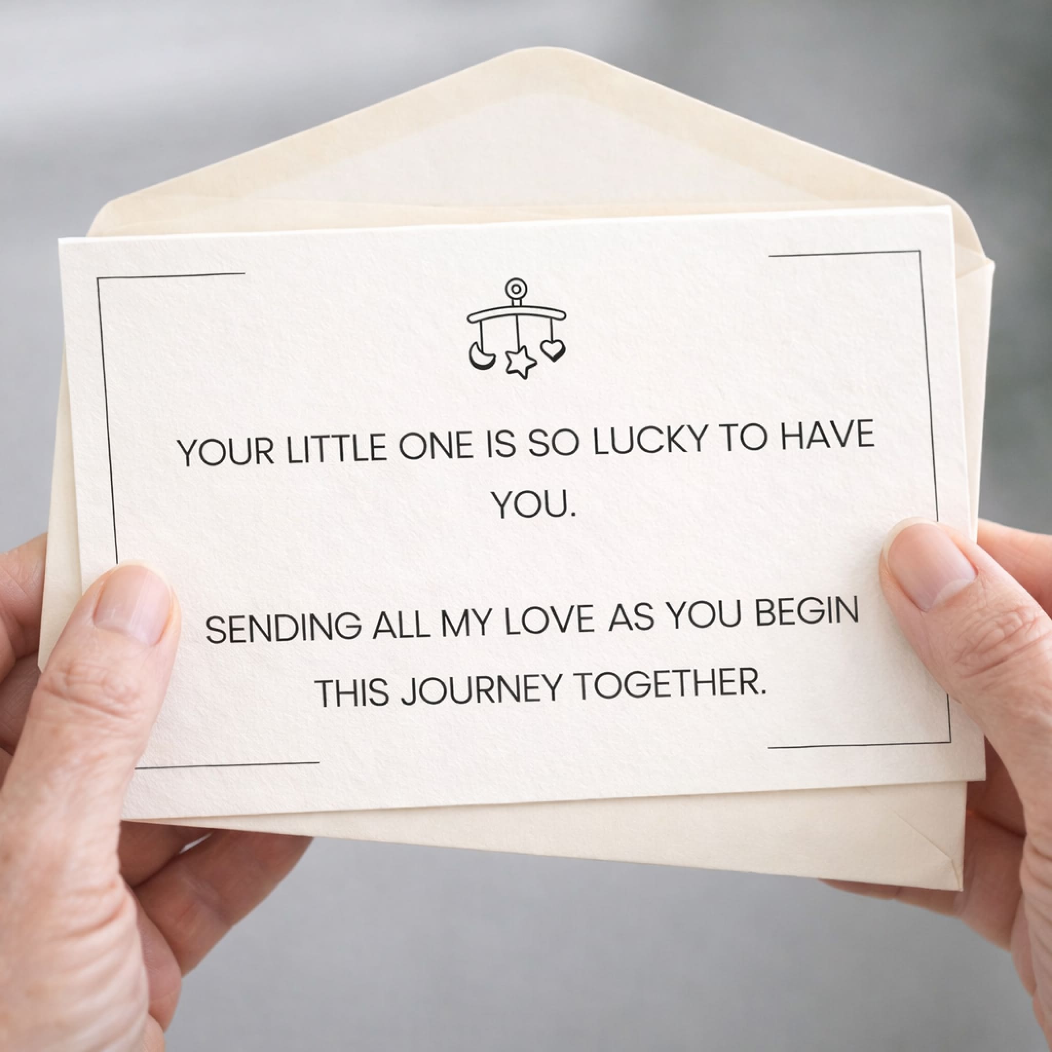 Card with a message of support and love held by hands against a neutral background