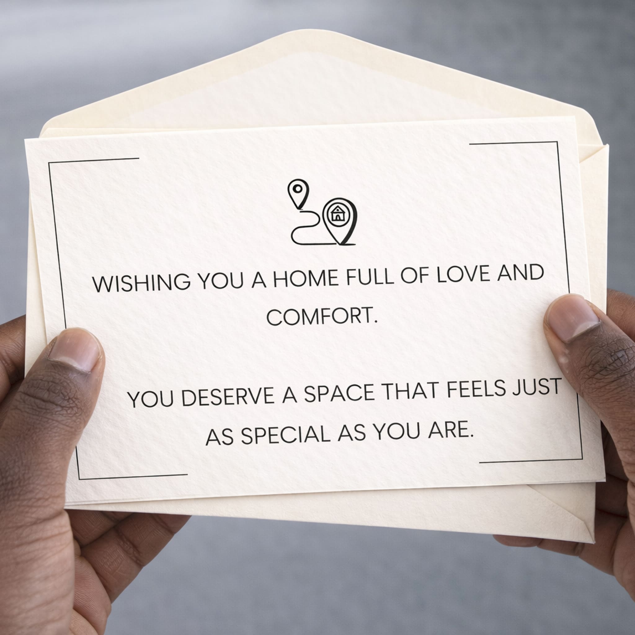 Hand holding a card with a message of encouragement against a gray background