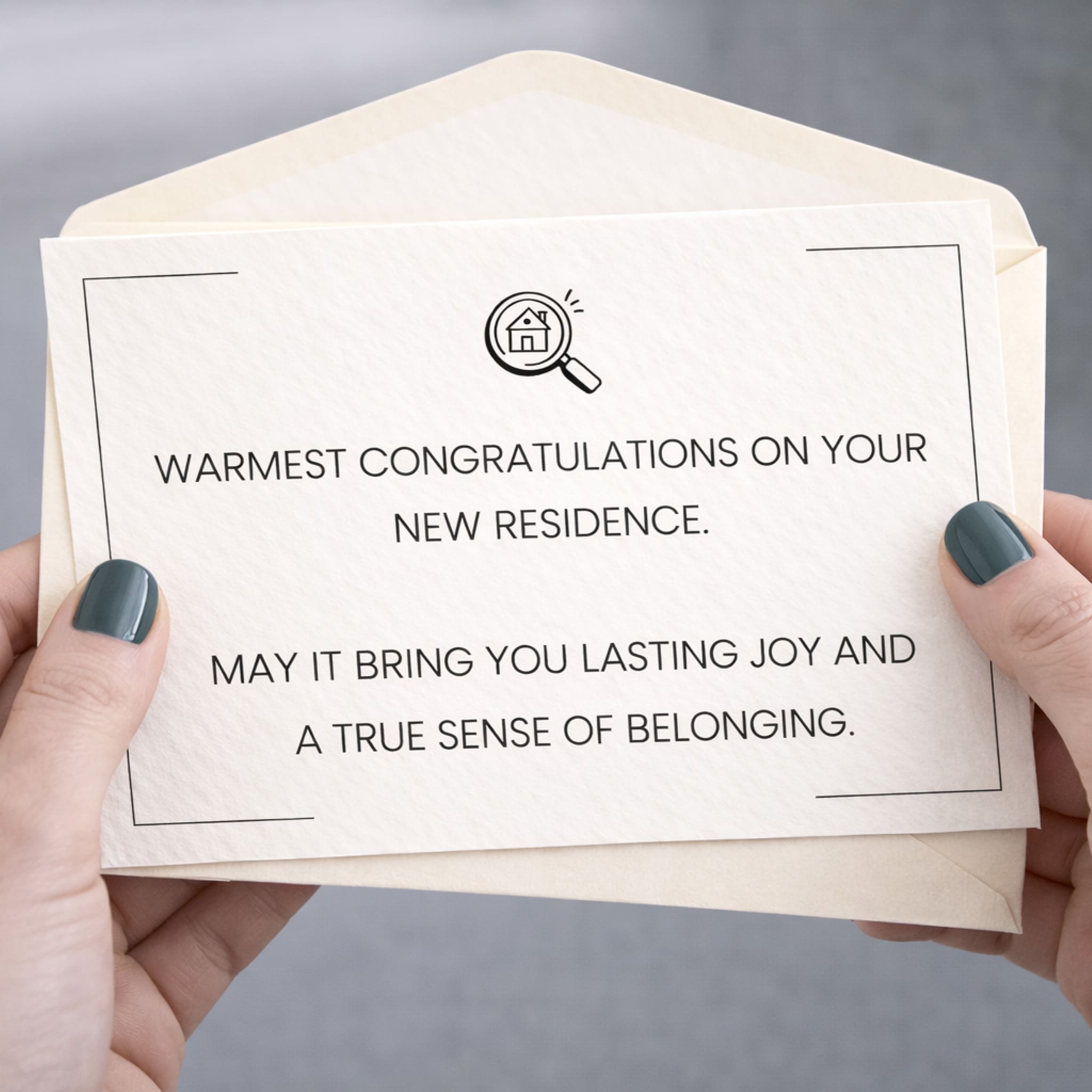 Hand holding a card with congratulations on new residence text